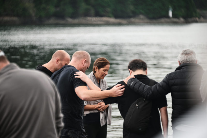 Photo of people praying at a baptism